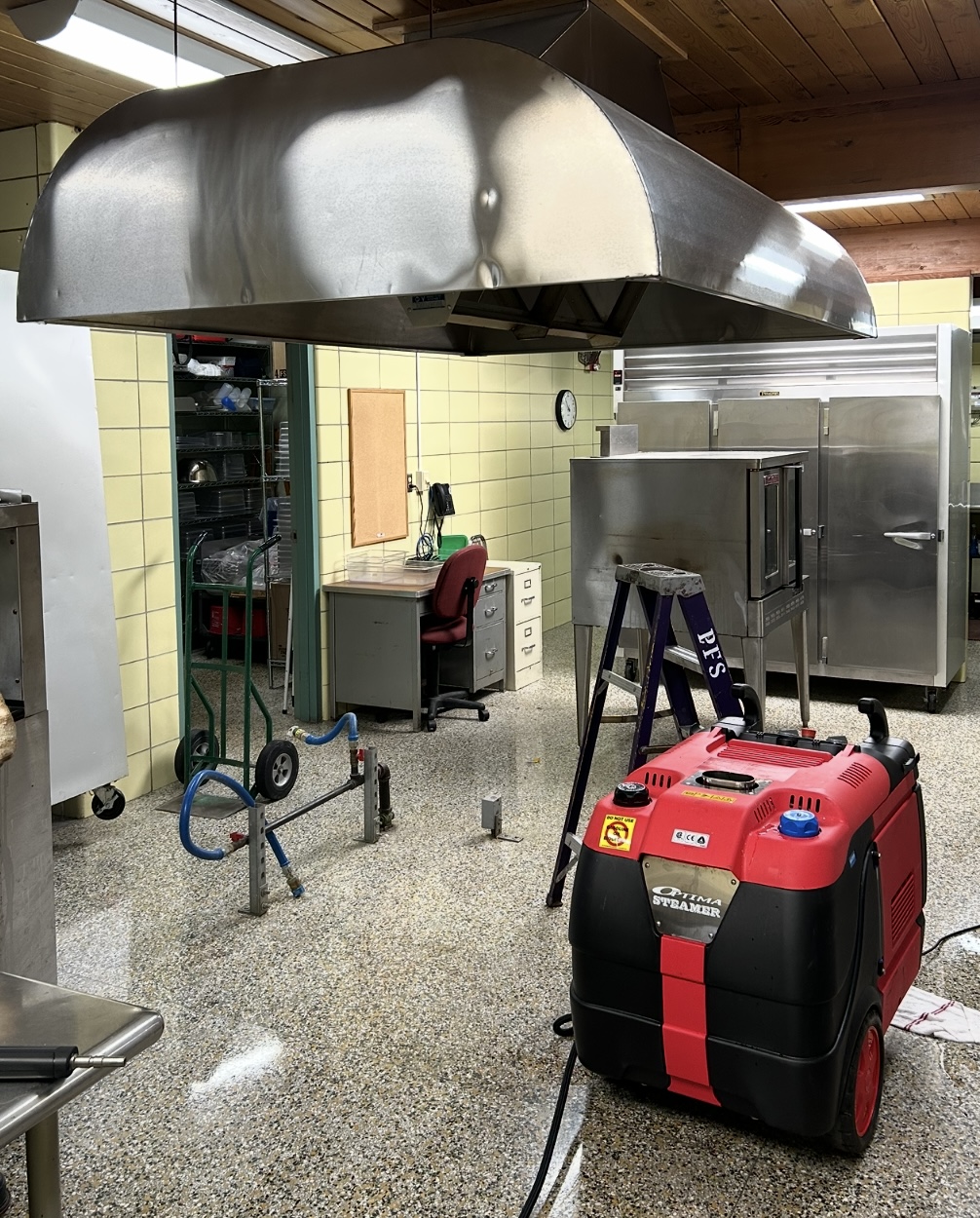 Professional hood cleaning equipment and freshly cleaned commercial kitchen hood