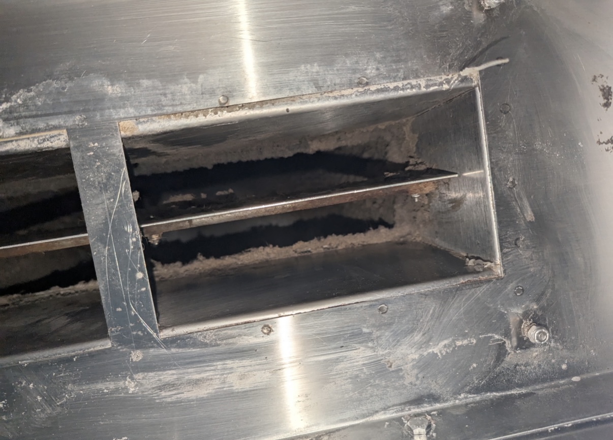Interior ductwork showing grease accumulation on damper blades